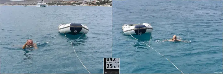 Mann schwimmt im Meer vor Porto Santo, gibt Daumen hoch. Ein Schlauchboot treibt daneben.